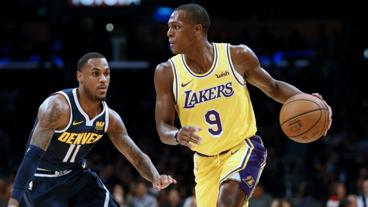 Rajon Rondo (9) sets up the Lakers' offense during a preseason game against the Nuggets.