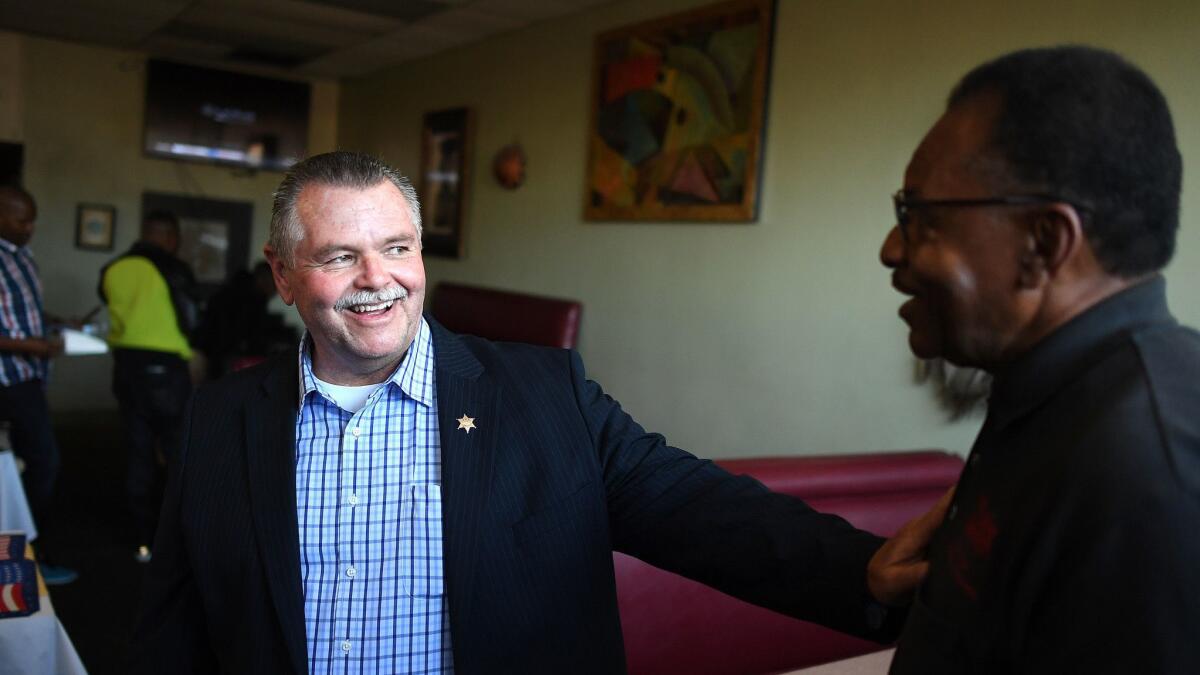Retired Sheriff's Cmdr. Bob Lindsey, campaigning Friday at Nkechi African cafe in Inglewood, has more money behind him than the incumbent in the race for L.A. County sheriff.