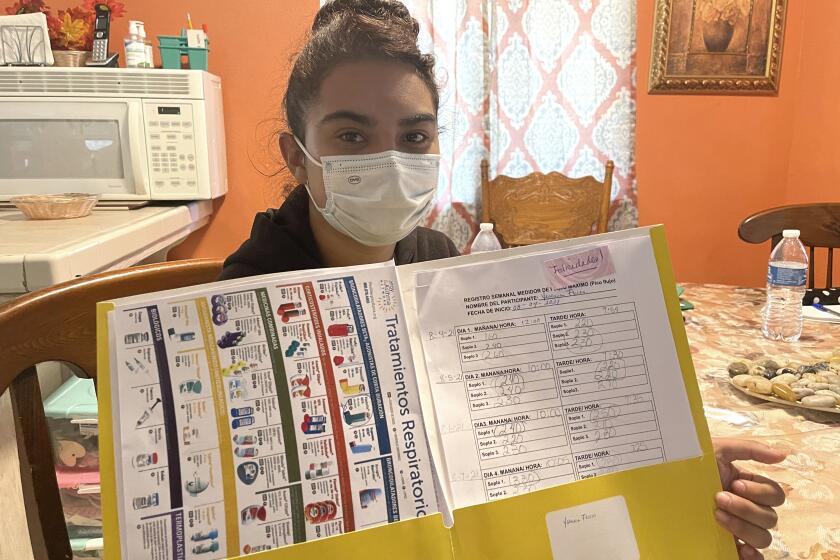 Yesenia Flores-Cabrera, who has asthma, tracks her lung capacity.