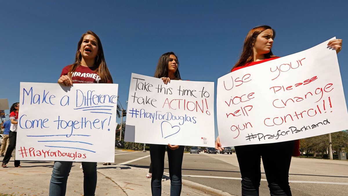 Young protesters gather Feb. 16 on a corner near Marjory Stoneman Douglas High School in Parkland, Fla., to call for gun control after a gunman killed 17 and injured 14.