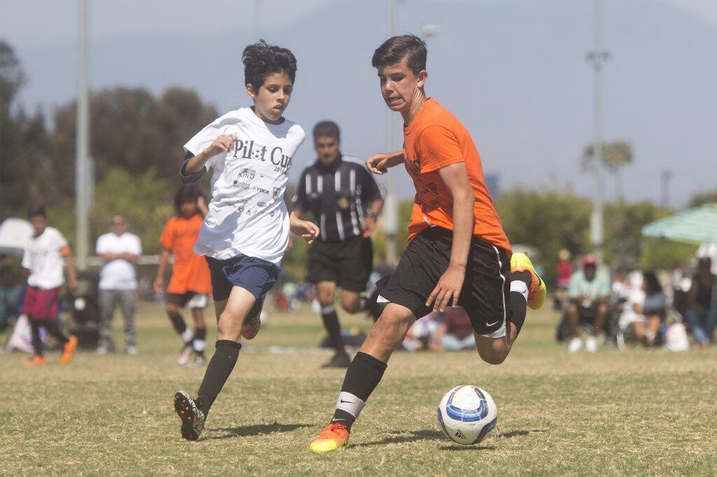 Whittier's Alex Barajas, left, and Davis' Trevor Trepas compete for possession of the ball during the boys' 5-6 Gold Division championship game of the Daily Pilot Cup Sunday afternoon.