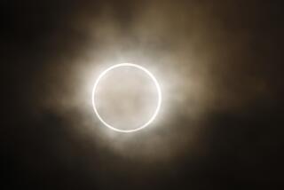 An annular eclipse is viewed from a waterfront park in Yokohama, Japan, near Tokyo, Monday, May 21, 2012. 