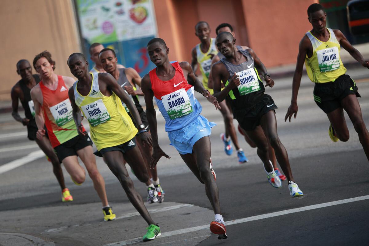 Now that requires a long-term commitment: Eventual men's winner Erick Mose, left in green shoes, during the 2013 L.A. Marathon.
