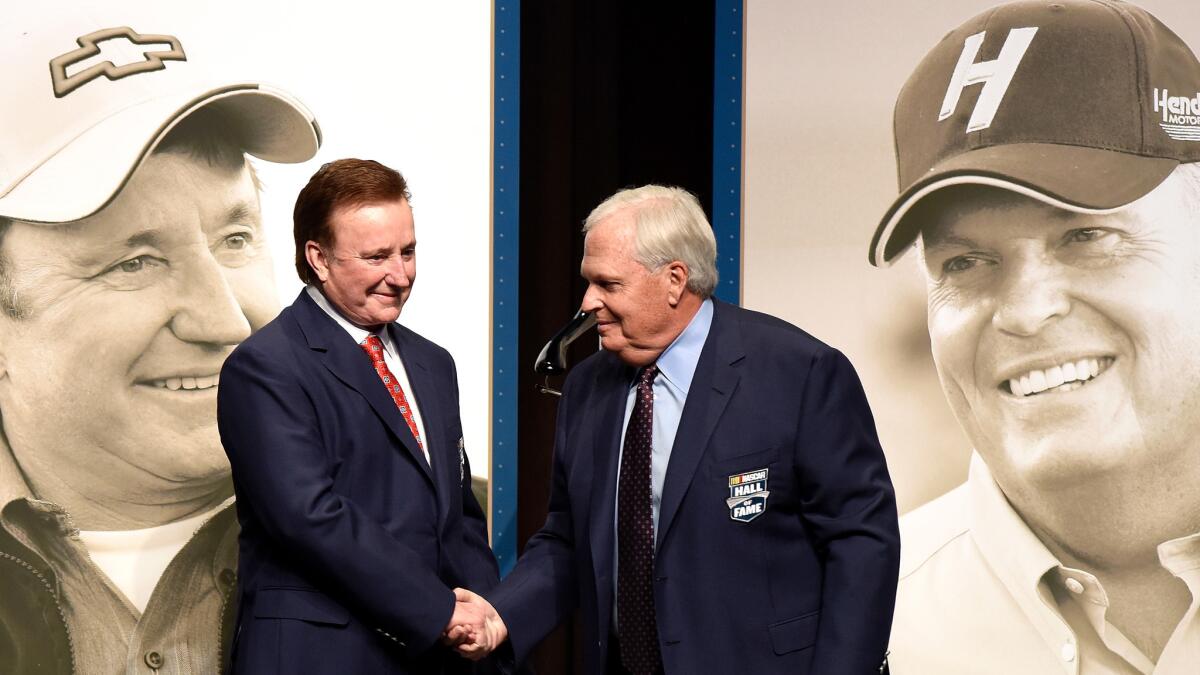 NASCAR Hall of Fame inductees Richard Childress, left, and Rick Hendrick shake hands after receiving their jackets before the induction ceremony on Friday night.