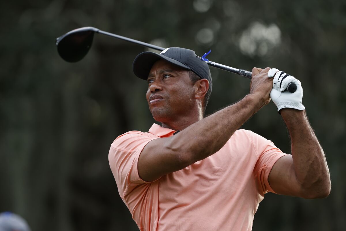 Tiger Woods tees off on the 15th hole during the first round of the PNC Championship on Dec. 18, 2021.
