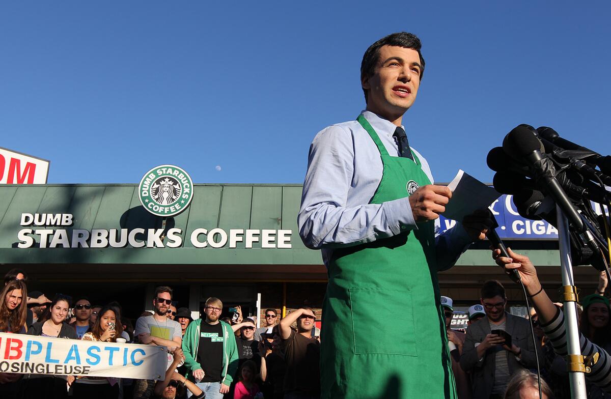 Nathan Fielder reveals his ownership of Dumb Starbucks in front of reporters and onlookers outside his shop in Los Feliz. Fielder has a show on Comedy Central called "Nathan for You".