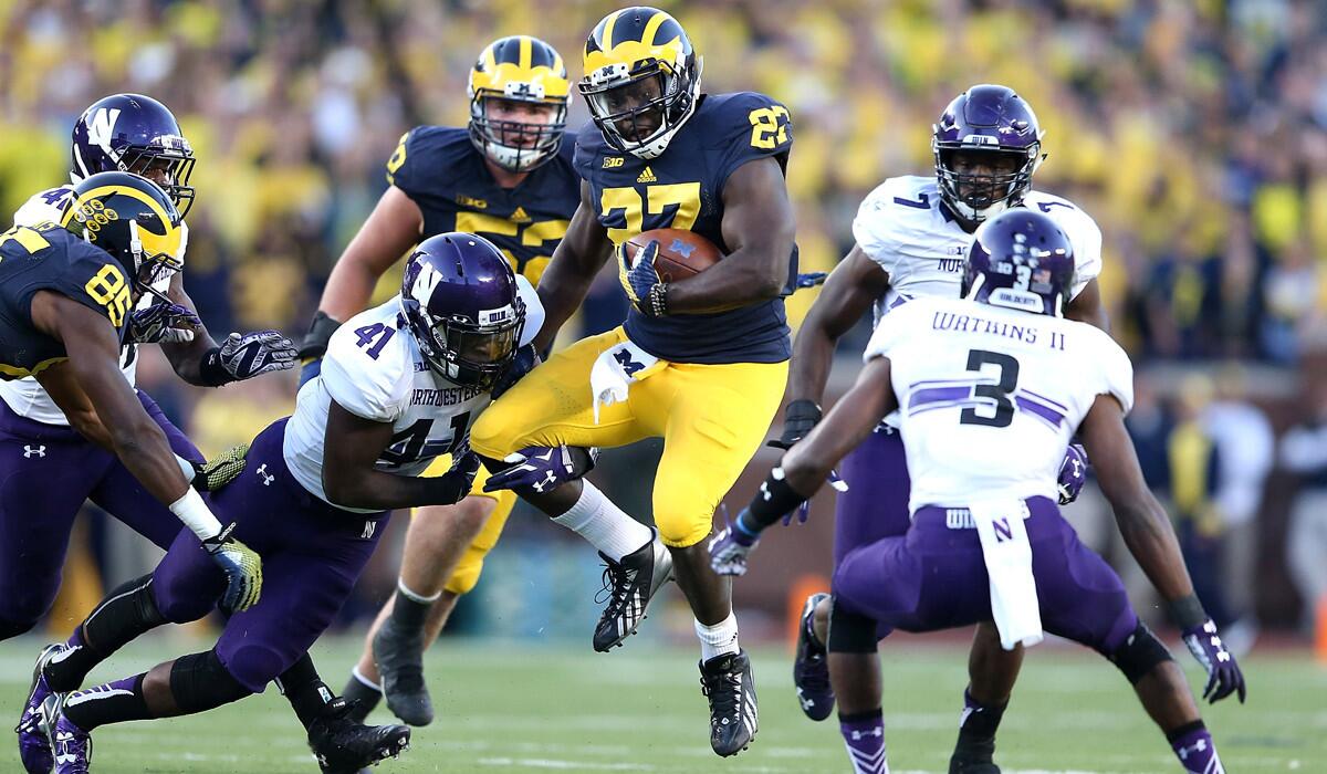 Michigan running back Derrick Green runs for a first down during the fourth quarter against Northwestern defenders on Saturday.