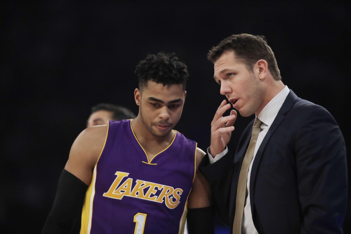 Lakers Coach Luke Walton talks to point guard D'Angelo Russell (1) during the first half of a game against the Knicks on Feb. 6.
