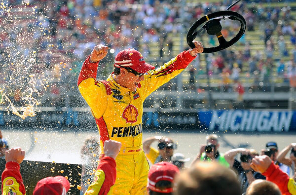 NASCAR driver Joey Logano celebrates after winning the Sprint Cup race at Michigan International Speedway on Sunday.