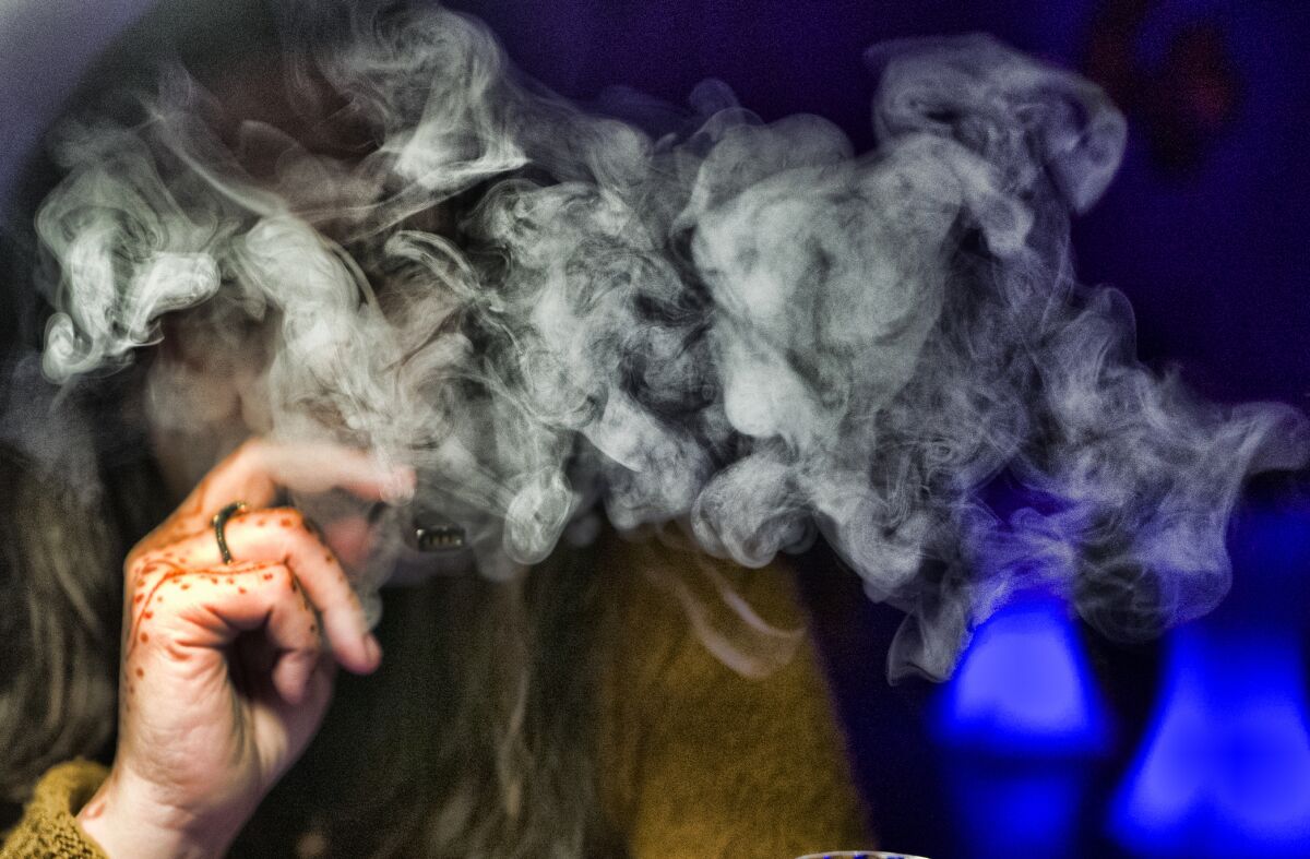  a guest takes a puff of a cannabis vape pen during a marijuana event in downtown Los Angeles. 
