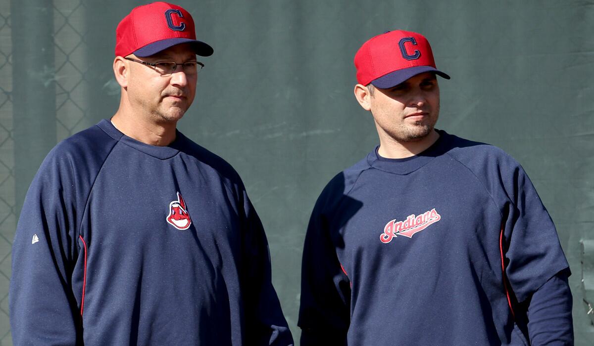 Cleveland Indians Manager Terry Francona, left, and bullpen coach Kevin Cash watch players go through drills in spring training of 2013.
