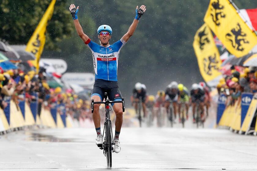 Ramunas Navardauskas of Lithuania celebrates as he rides to victory in the 19th stage of the Tour de France in Bergerac, France.