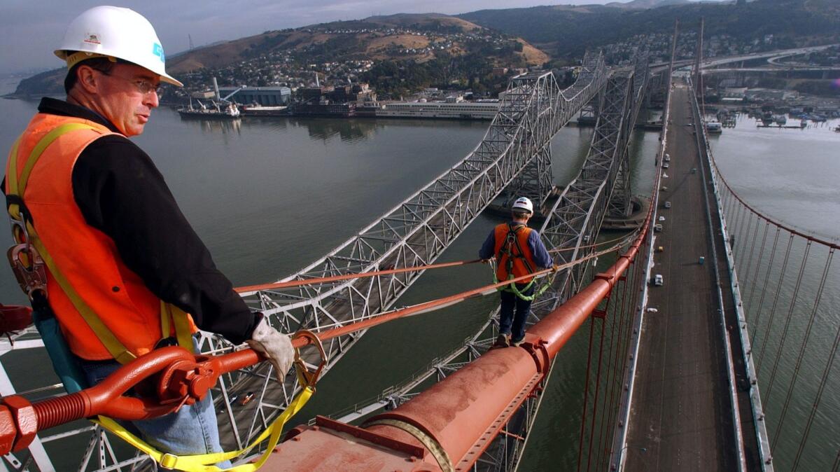 An engineer walks along the span on the Alfred Zampa Memorial Bridge in Vallejo, Calif. on Nov. 5, 2003.