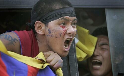 A Tibetan demonstrating against the Chinese crackdown in Tibet yells after his arrest in front of the Chinese embassy in New Delhi.