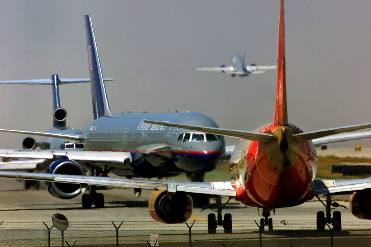 Planes line up for takeoff at Los Angeles International Airport.