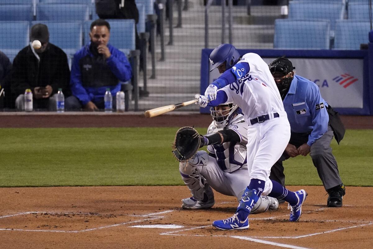 Chris Taylor hits a solo home run against the Colorado Rockies on Tuesday.