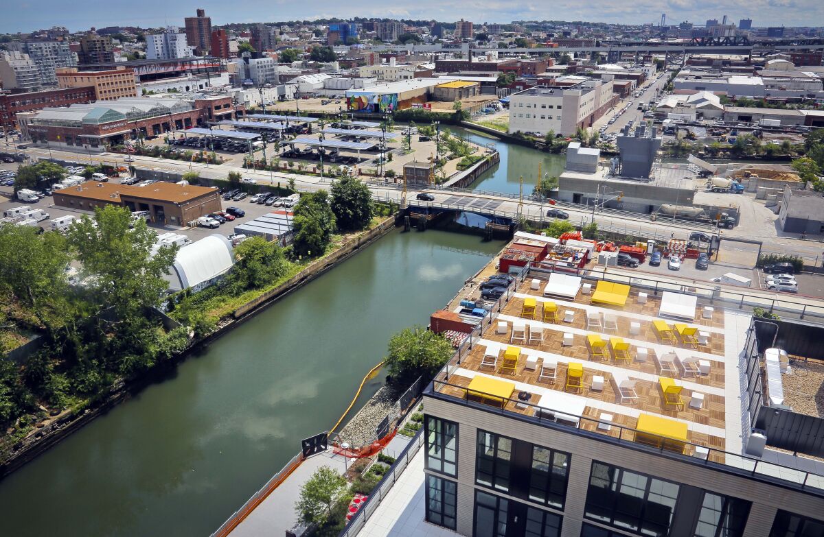 FILE — This photo shows a view of Brooklyn's Gowanus Canal, July 5, 2016, in New York. A decade after Superstorm Sandy pummeled New York and New Jersey in one of the costliest storms in U.S. history, the federal government is proposing a $52 billion plan to build movable barriers and gates across bays, rivers and other waterways in the two states hardest-hit by the storm. (AP Photo/Bebeto Matthews, File)