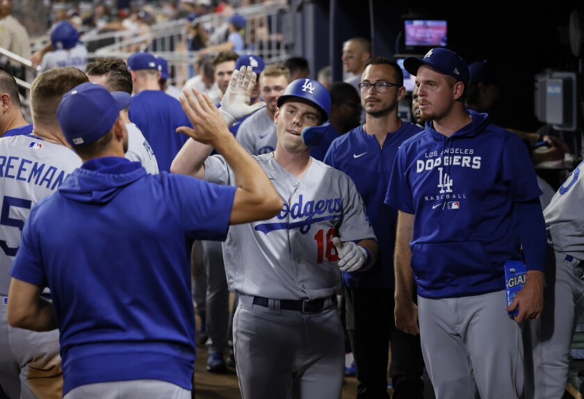 The Dodgers' Will Smith is congratulated in the dugout after tying the score with an eighth-inning homer June 25, 2022.