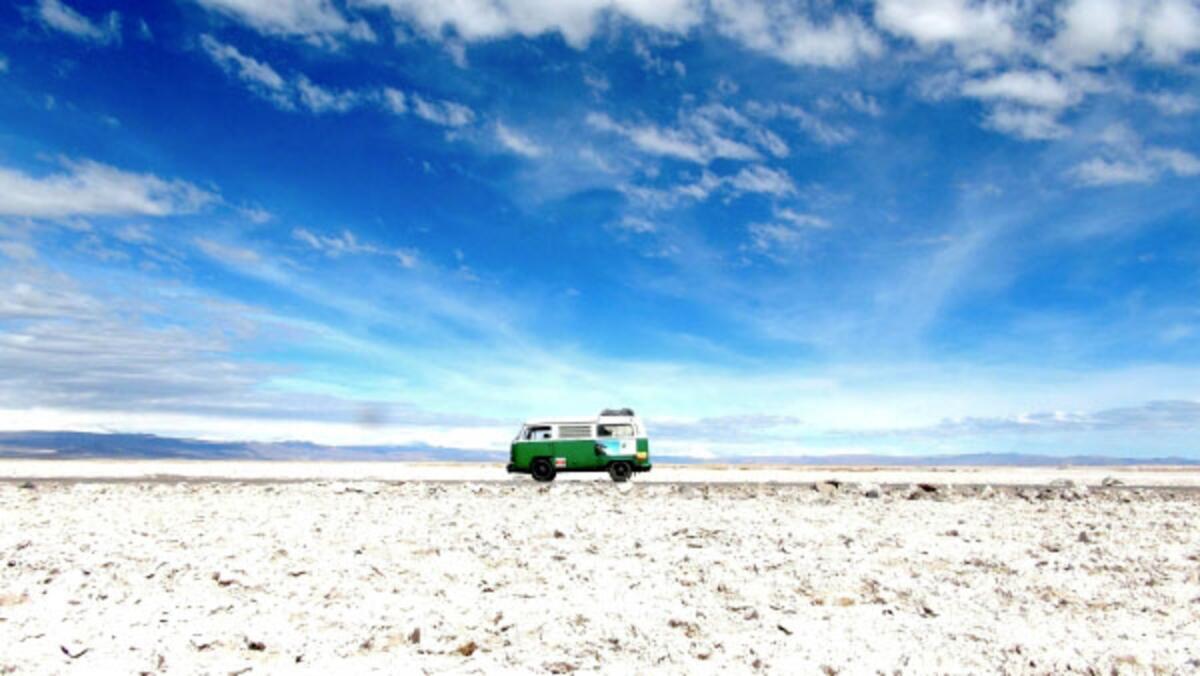 The van parks on salt flats in Chile's Atacama Desert.