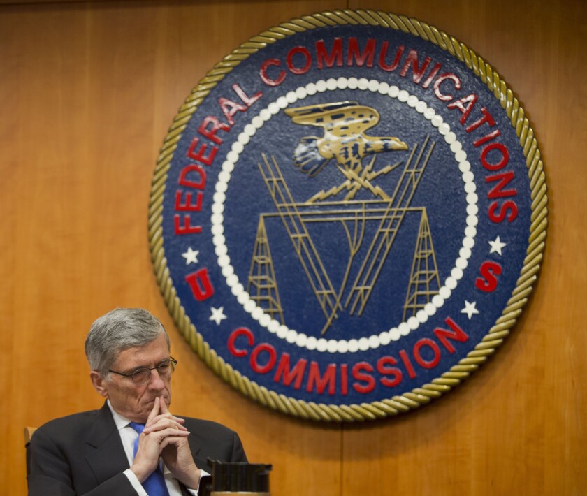 Federal Communications Commission Chairman Tom Wheeler listens to commissioners speak prior to a vote on net neutrality regulations in 2015.