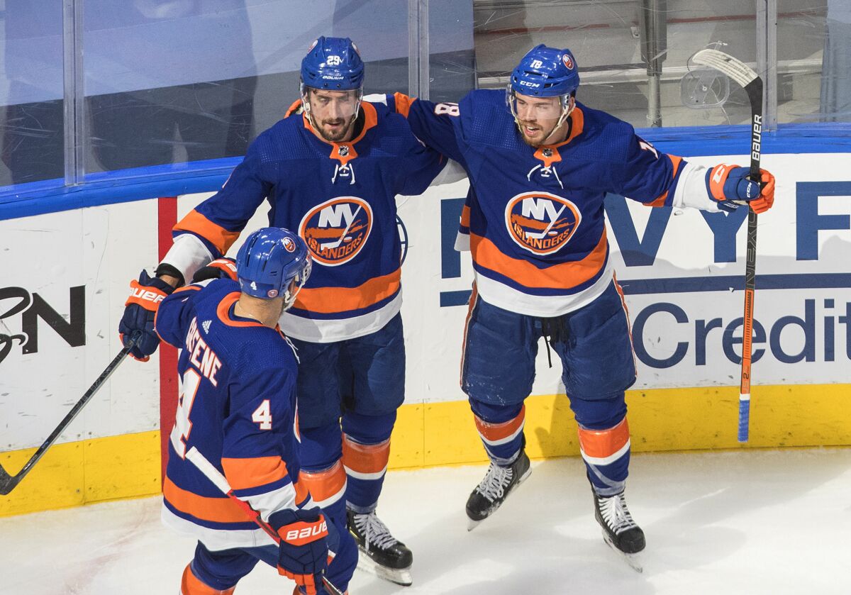 New York Islanders' Andy Greene (4), Brock Nelson (29) and Anthony Beauvillier (18) celebrate a goal on the Tampa Bay Lightning during the second period of Game 3 of the NHL hockey Eastern Conference final, Friday, Sept. 11, 2020, in Edmonton, Alberta. (Jason Franson/The Canadian Press via AP)
