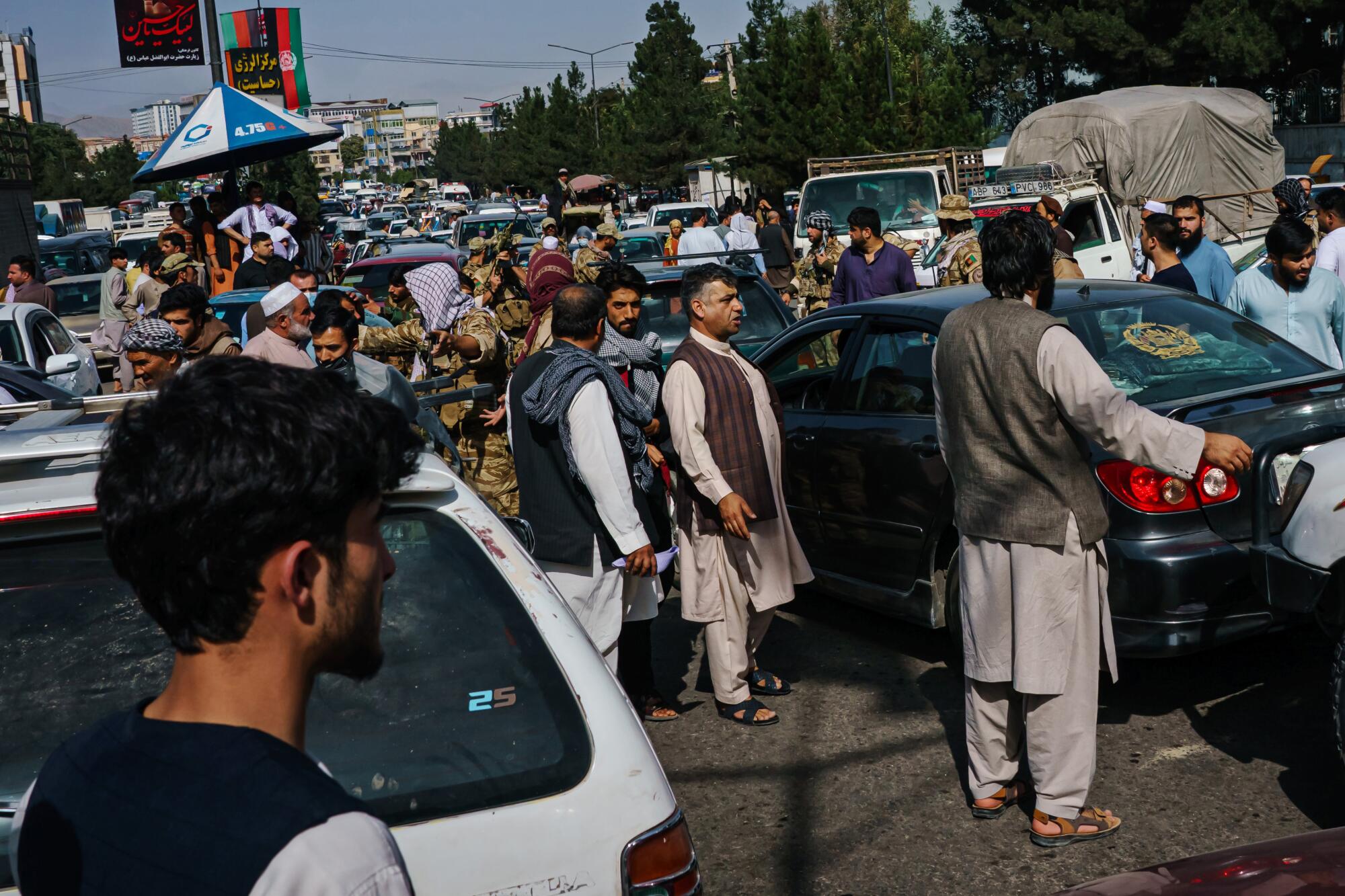  Pedestrians and motorists in a traffic gridlock on a street.