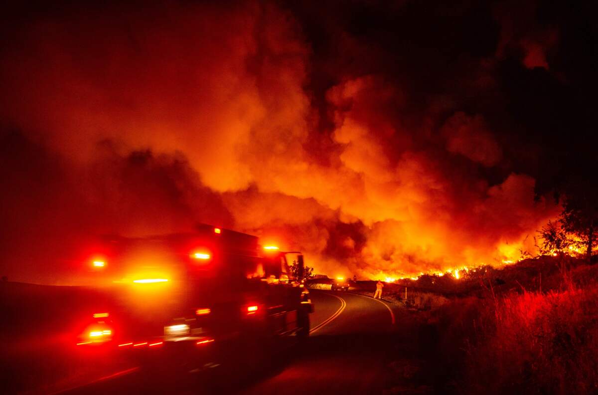 A firetruck heads toward flames during the Kincade fire near Geyserville, Calif., on Oct. 24. The fire broke out in spite of rolling blackouts by utility companies in both Northern and Southern California.