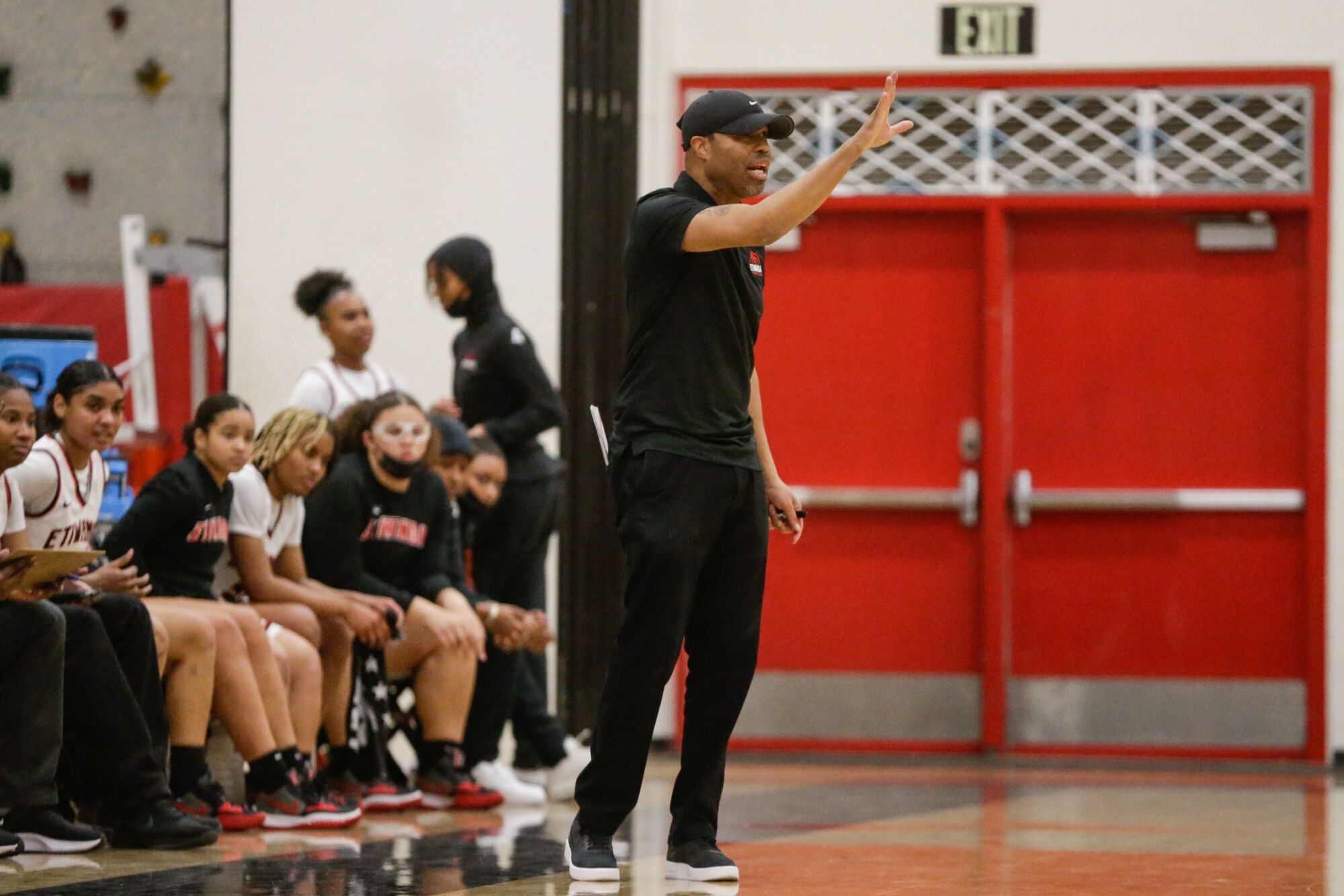 Etiwanda coach Stan Delus gives instructions to his players on the court from the sideline.