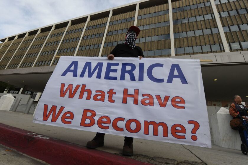 Immigrant rights groups protest on January 29, 2018, outside the Federal Building in Los Angeles, against the arrest of a Tucson-based 'No More Deaths' group activist. The activist was arrested by border patrol in a remote area of Arizona afterleaving water for immigrants crossing from Mexico. / AFP PHOTO / Mark RALSTONMARK RALSTON/AFP/Getty Images ** OUTS - ELSENT, FPG, CM - OUTS * NM, PH, VA if sourced by CT, LA or MoD **