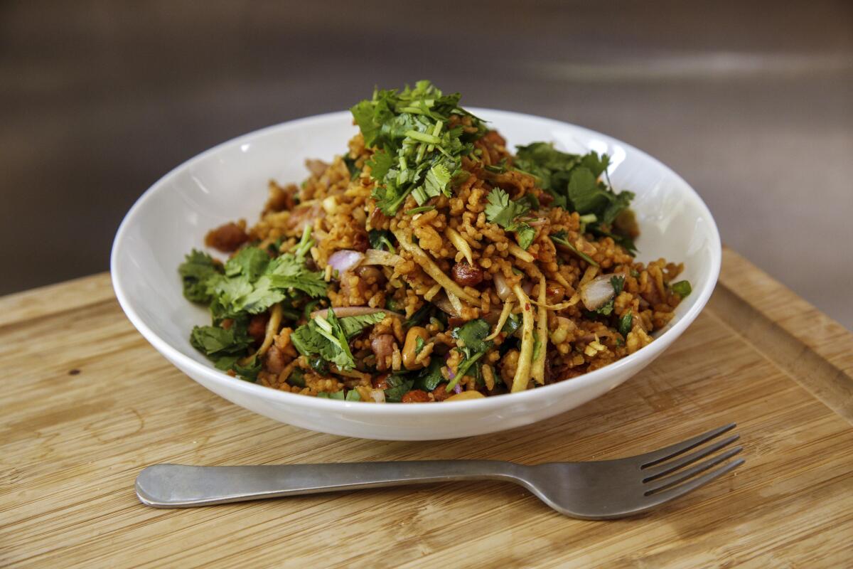 Chef Kris Yenbamroong's famous Nam Khao Tod, a Thai toasted rice salad, at his home on July 31, 2015.