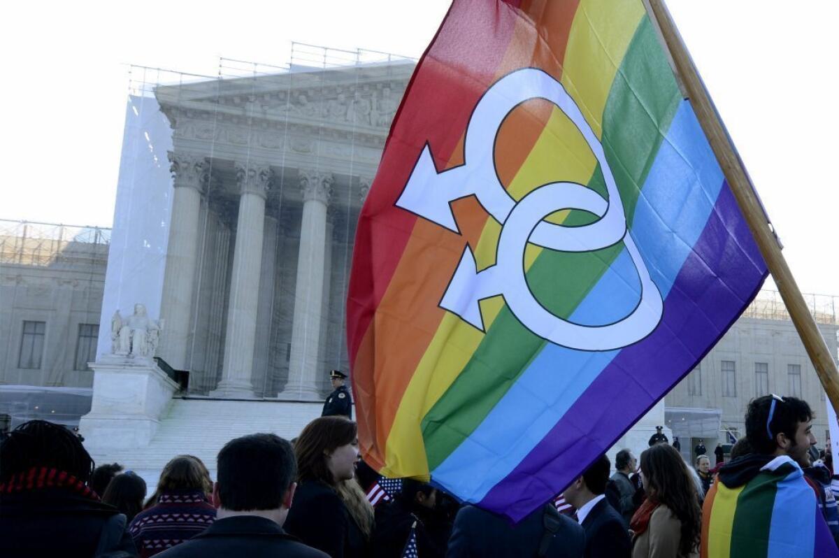 Same-sex marriage supporters demonstrate outside the Supreme Court in March on the day when the justices heard oral arguments on the Defense of Marriage Act.