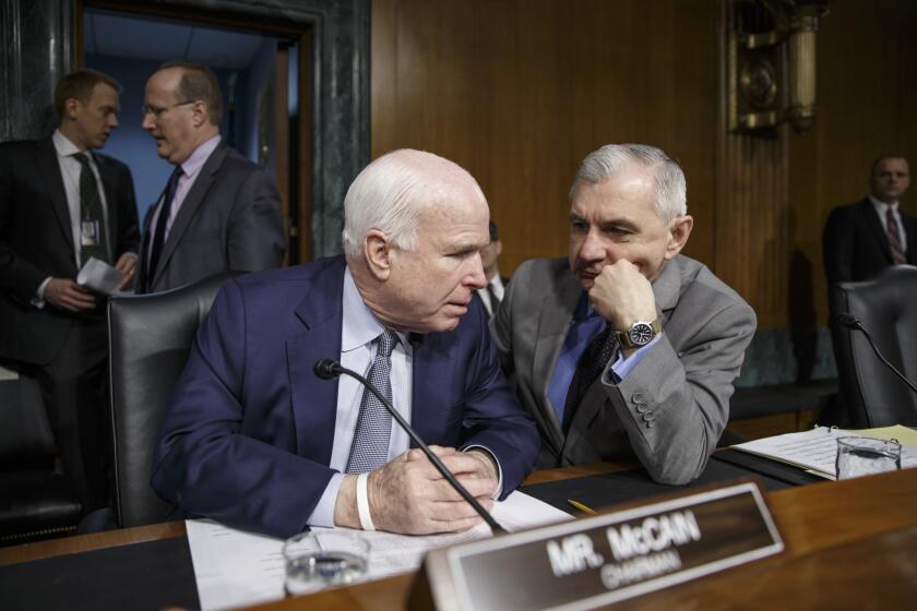 Senate Armed Services Committee Chairman John McCain (R-Ariz.), left, talks with Sen. Jack Reed (D-R.I.) on Capitol Hill in Washington on Feb. 26 before a hearing.