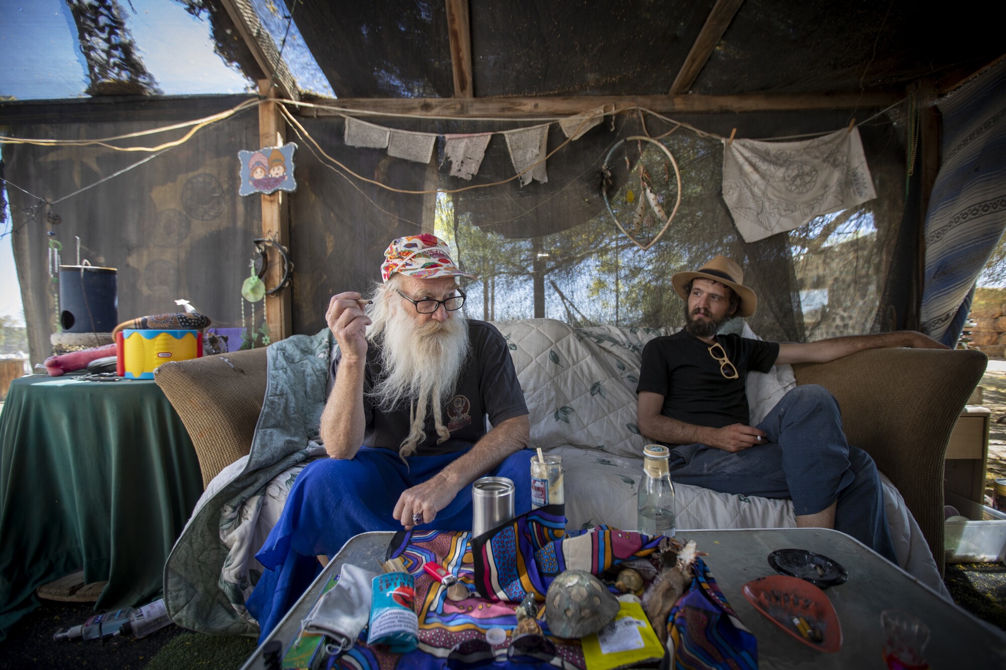 Bob Johnson, left, and Matt Crow relax at Johnson's Slab City Hostel.