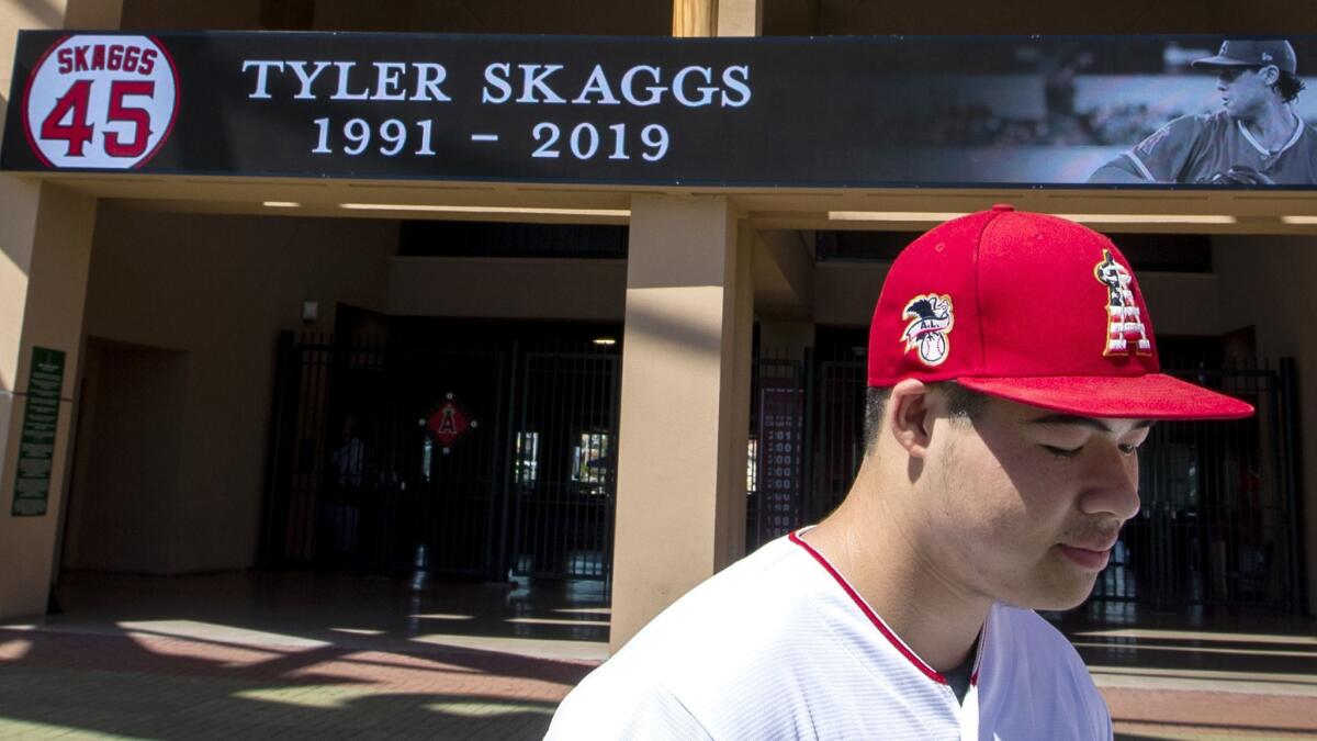 Angels fan Reza Agahi of Anaheim spends a quiet moment at Angel Stadium after learning of pitcher Tyler Skaggs' death on Monday.