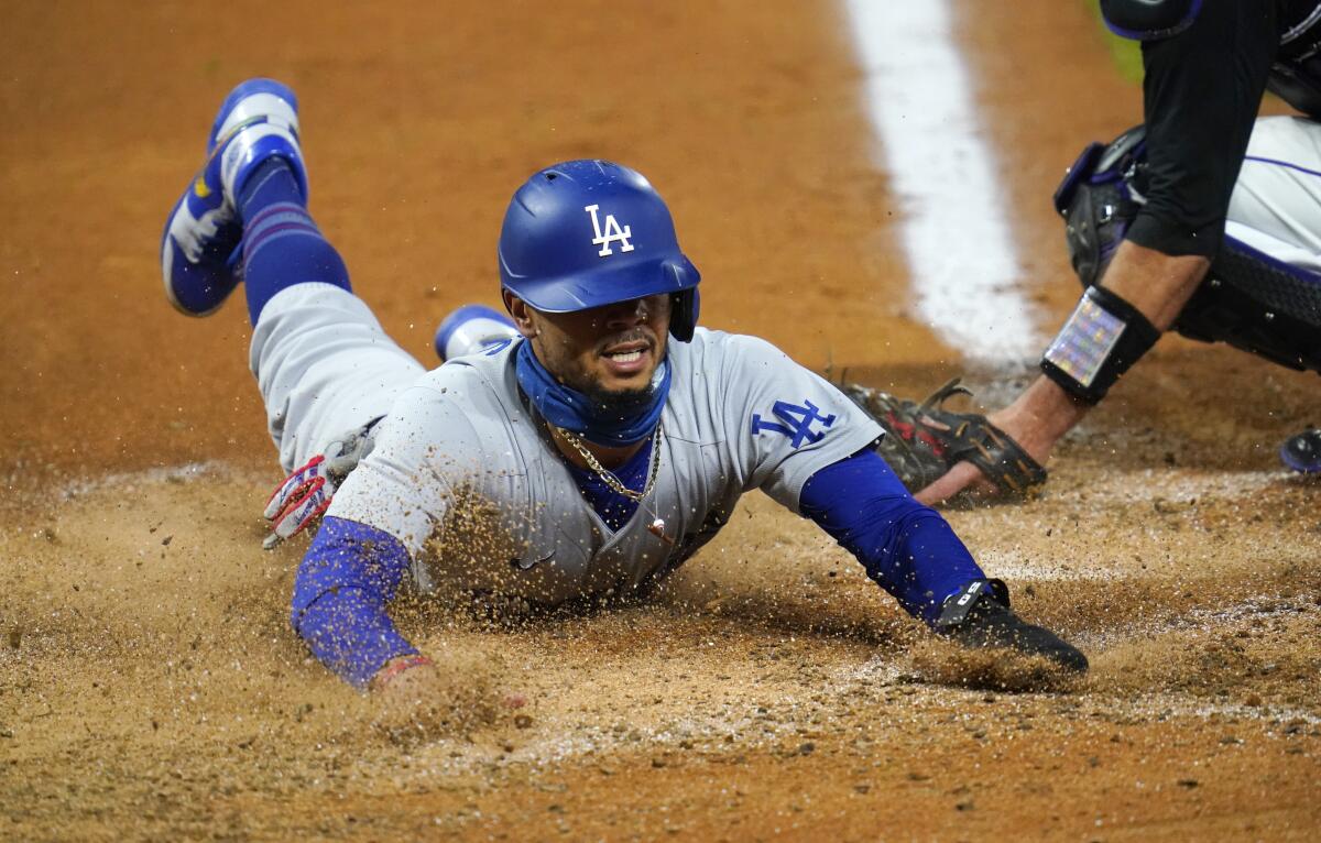 Dodgers right fielder Mookie Betts scores from second base after a bad pickoff throw by the Colorado Rockies.