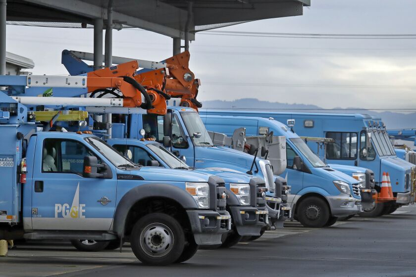 FILE - In this Jan. 14, 2019, file photo, Pacific Gas & Electric vehicles are parked at the PG&E Oakland Service Center in Oakland, Calif. Pacific Gas & Electric said it will shut off power Saturday, June 8, to about 1,600 customers in Northern California and may do the same for thousands more to reduce the risk of wildfires. The utility announced Friday night that as of Saturday morning it will turn off electricity to customers in Napa, Solano and Yolo counties west of Sacramento. (AP Photo/Ben Margot, File)