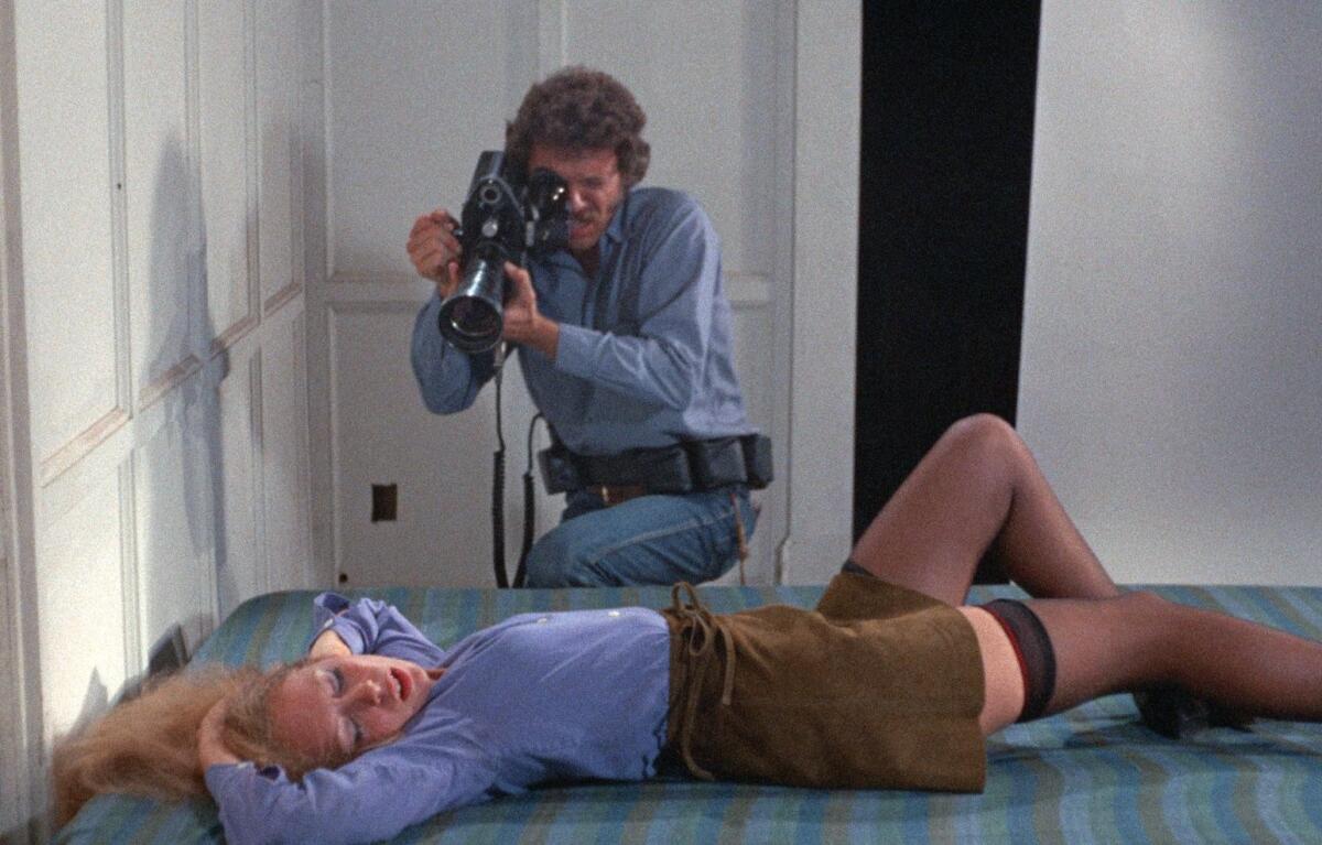 A man films a woman in repose.
