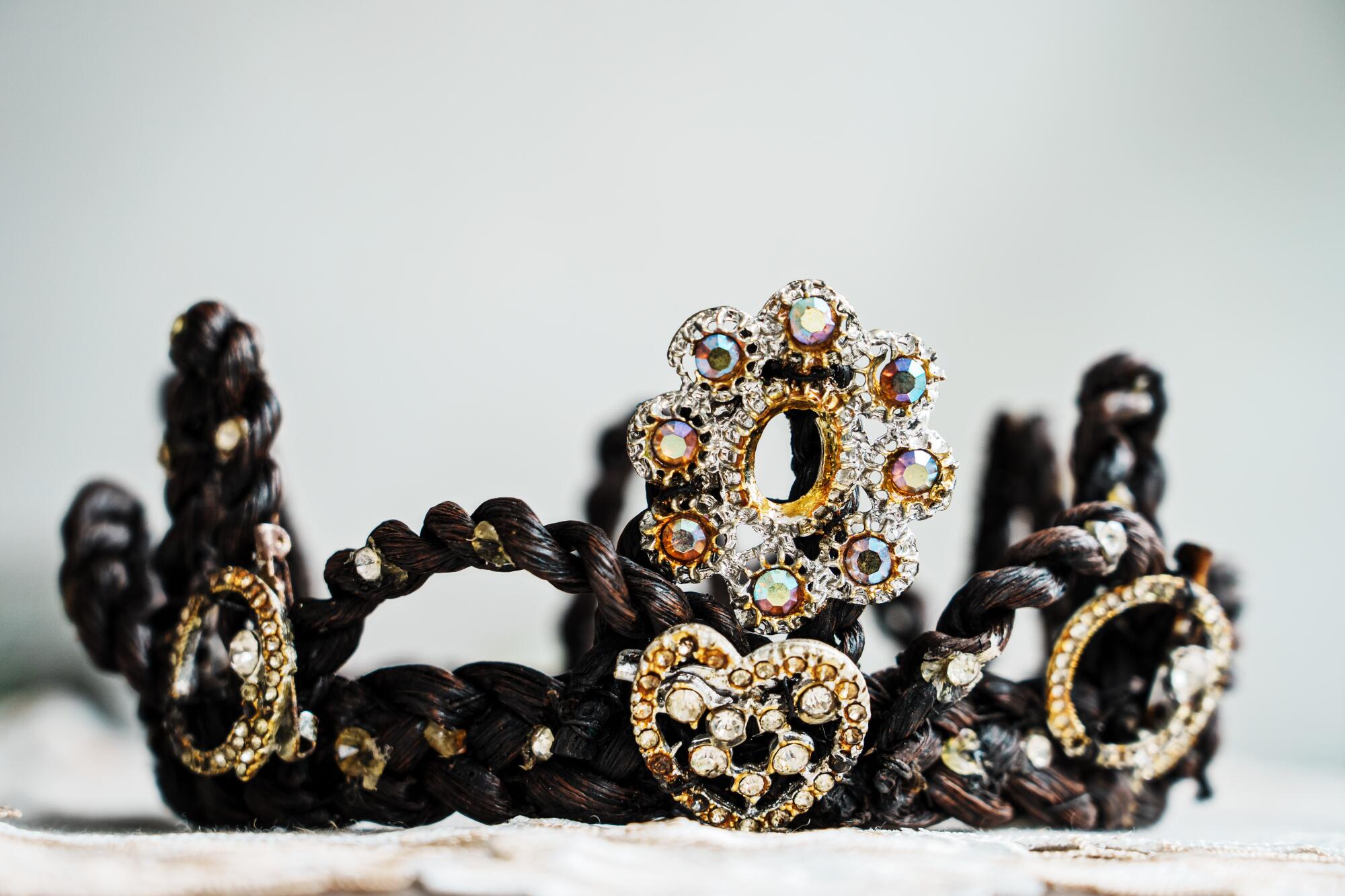 A crown of woven vanilla pods embellished with hearts and jewels.