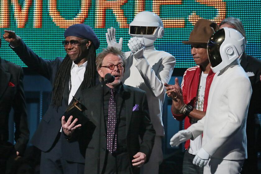Paul Williams accepts the Grammy and speaks after the album of the year win for Daft Punk's "Random Access Memory" on Sunday night. Behind him are Nile Rodgers, left, a Daft Punk member, Pharrell Williams and the second Daft Punk member.