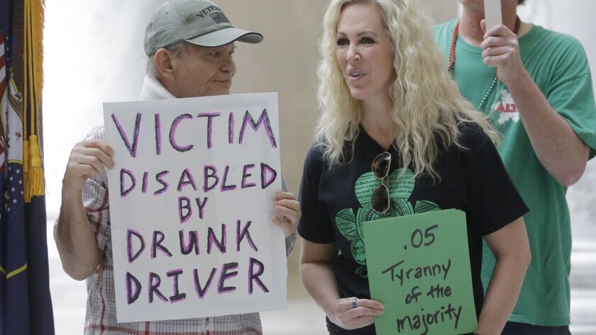 Ed Staley, left, and Tali Bruce attend a rally at the Utah state Capitol in 2017, the year the drunk-driving legislation was passed.