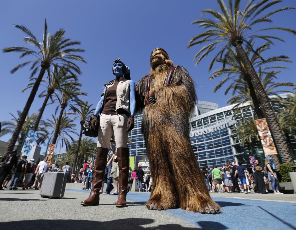 "Star Wars" fans Sharon Jackson, left, dressed as Mission Vao, of Las Vegas, and Kyle Jackson, dressed as a Wookiee, pose for pictures during the 2015 Star Wars Celebration at the Anaheim Convention Center on April 16.