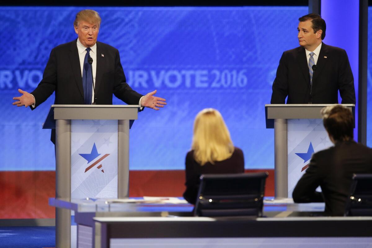 Donald Trump, left, answers a question as fellow Republican presidential candidate Sen. Ted Cruz, R-Texas, looks on during Saturday's debate.
