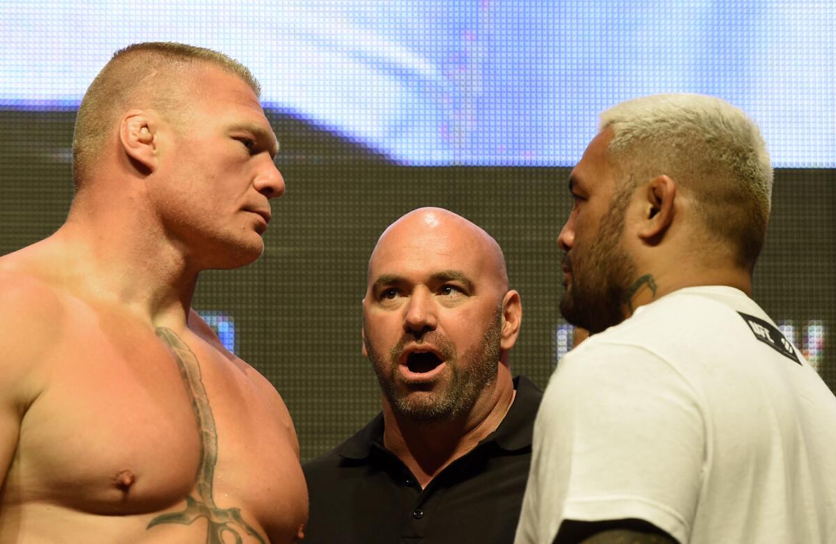 UFC President Dana White stands between fighters Brock Lesnar, left, and Mark Hunt during their weigh-in for UFC 200 on July 8.