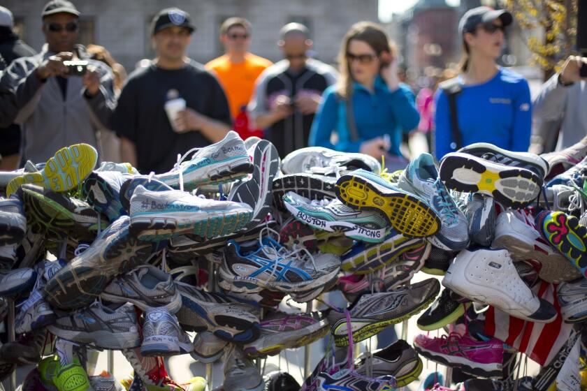 A collection of running shoes are part of a makeshift memorial honoring the victims of the Boston Marathon bombing in Copley Square in Boston.