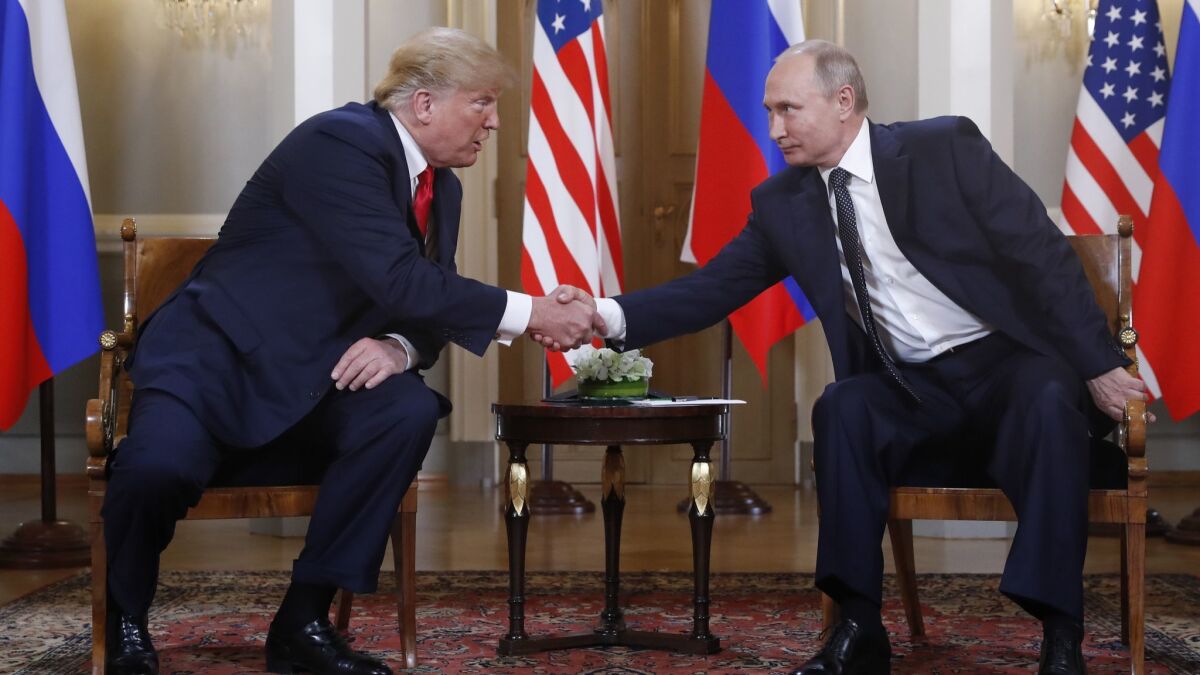 President Trump, left, and Russian President Vladimir Putin shake hands at the Presidential Palace in Helsinki, Finland, on Monday.