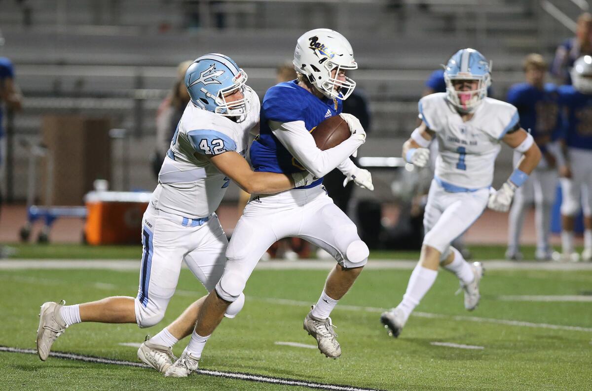 Corona del Mar linebacker Nathan Bloom (42) sacks Fountain Valley quarterback Jimmy Russell in a Sunset League game on Thursday at Huntington Beach High.