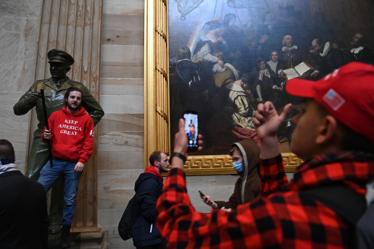 Supporters of President Trump pose for photos in the U.S. Capitol Rotunda