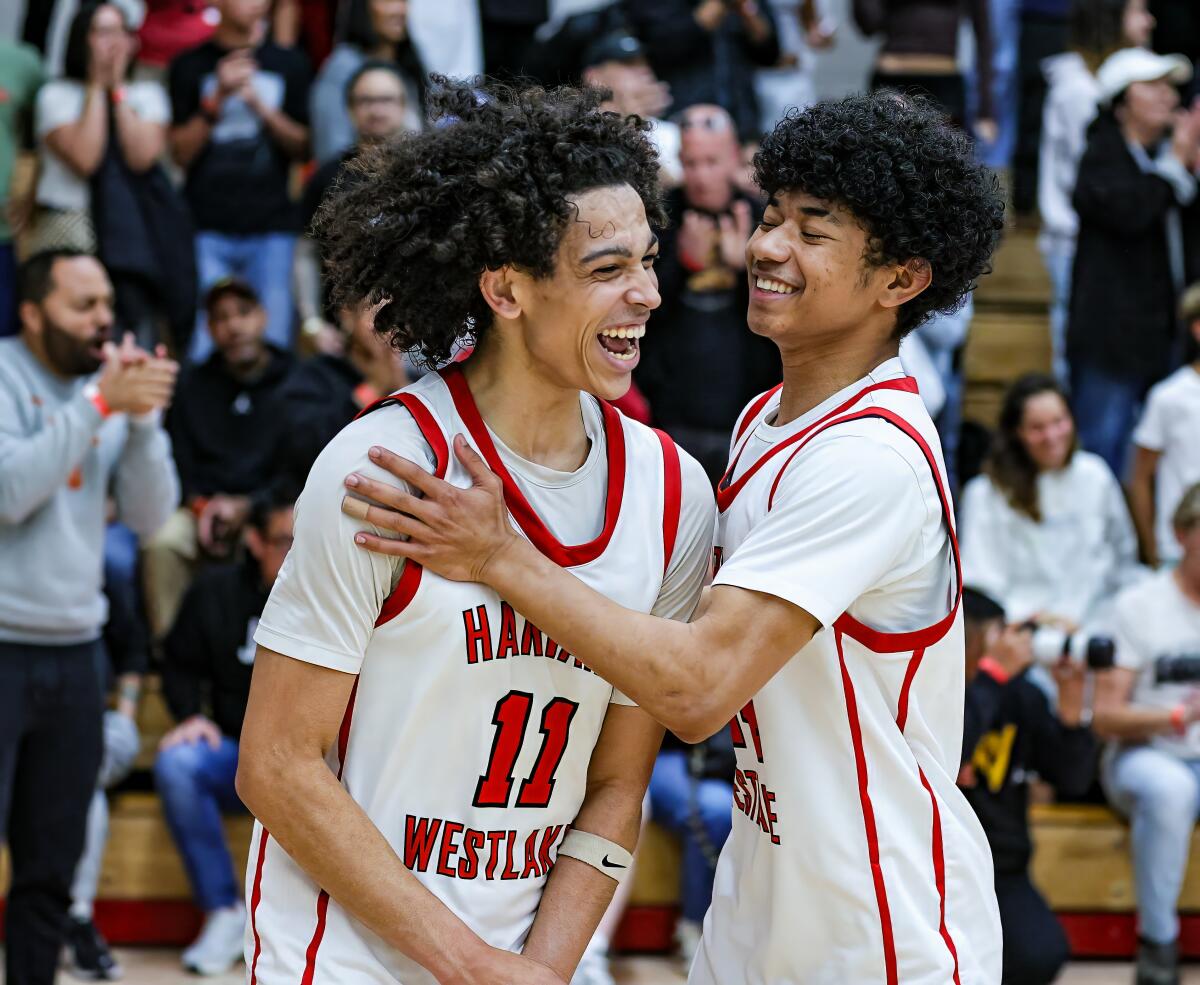 Pierce Thompson (left) receives congratulations from Miles Dodson after Harvard-Westlake's 56-52 victory over St. Joseph.