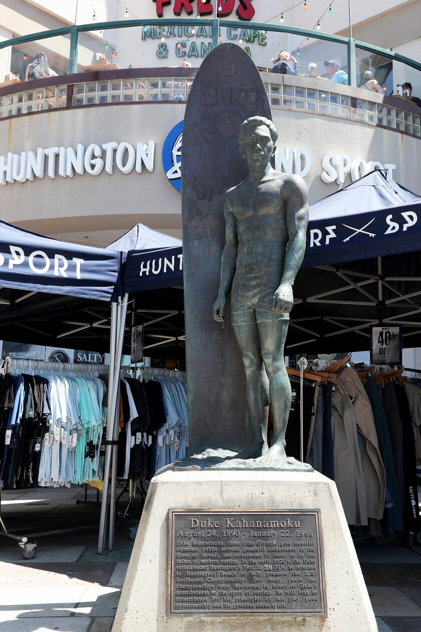 A statue of Hawaiian surf legend Duke Kahanamoku stands in front of Huntington Surf & Sport in Huntington Beach.