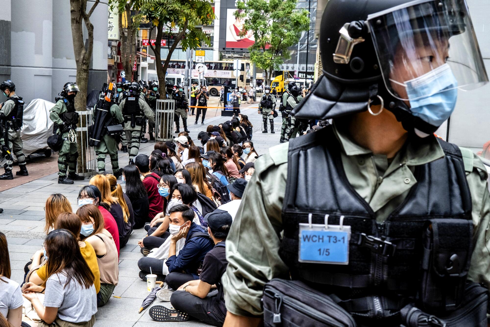 Riot police surround a group of pro-democracy protesters in Hong Kong.